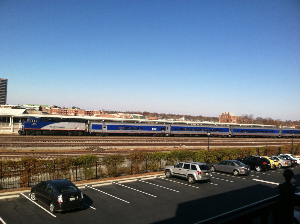 Mid-Day Piedmont train in route to Charlotte from Raleigh, as seen from the balcony of CityView Apartments in Greensboro. Photo by Kristen Jeffers, the author.